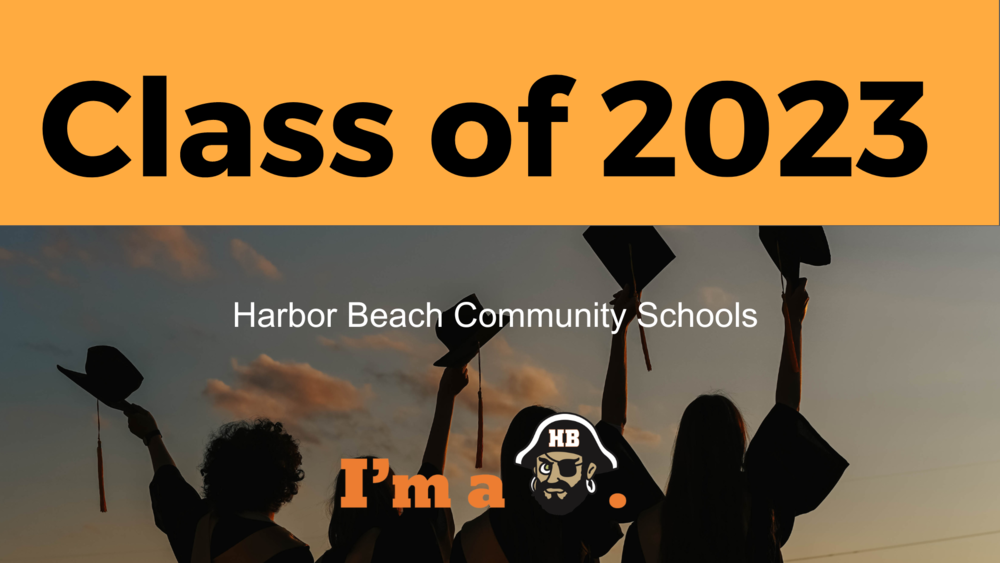 Graduates by a banner that says "Class of 2023"