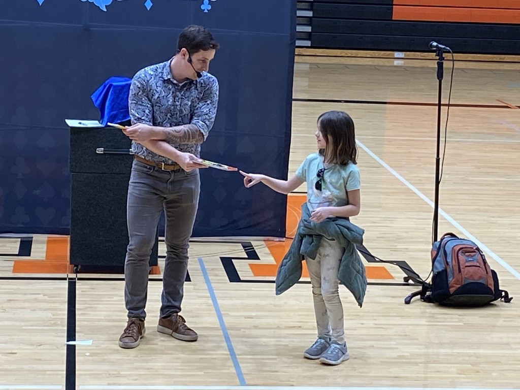 Student with magician in the gym