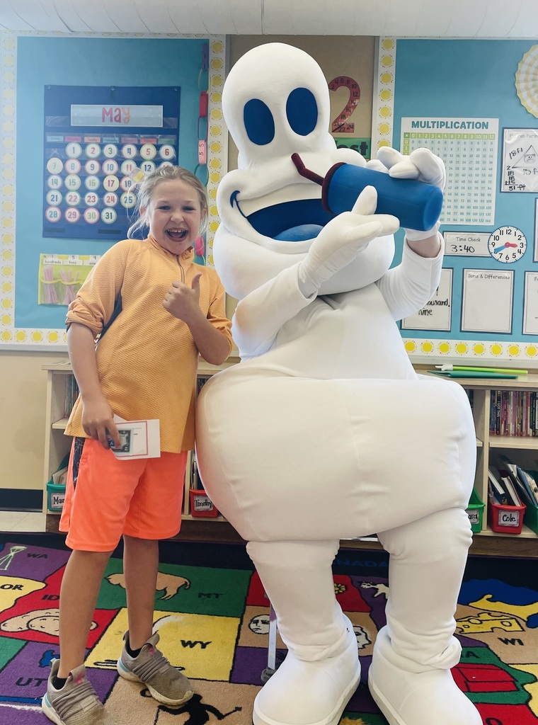 Speedy Q mascot with a 3rd grade student. 