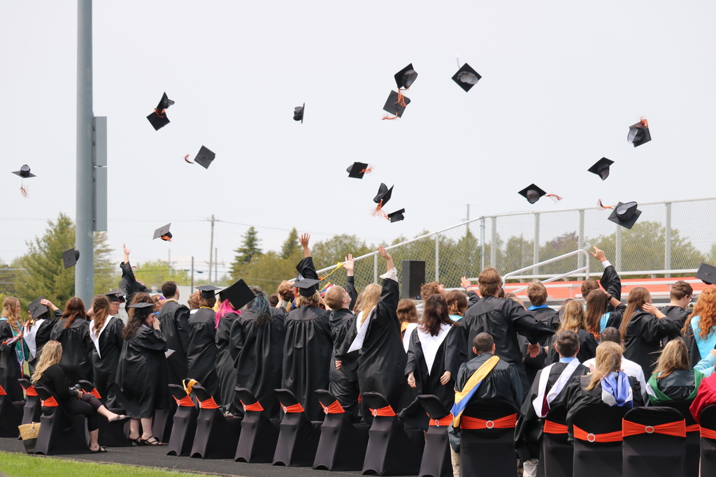 Graduates Hats Flying in Air